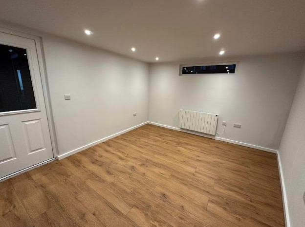 inside empty garden room with slot window and radiator