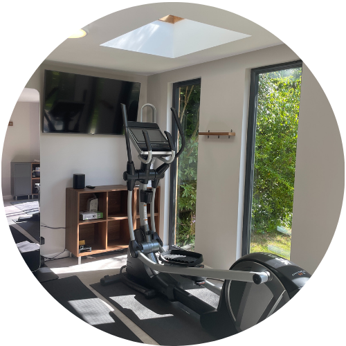 garden room gym in cheshire with equipment and full length windows
