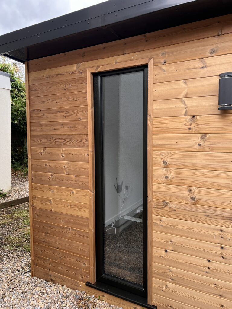 garden office showing floor to ceiling window and cladding