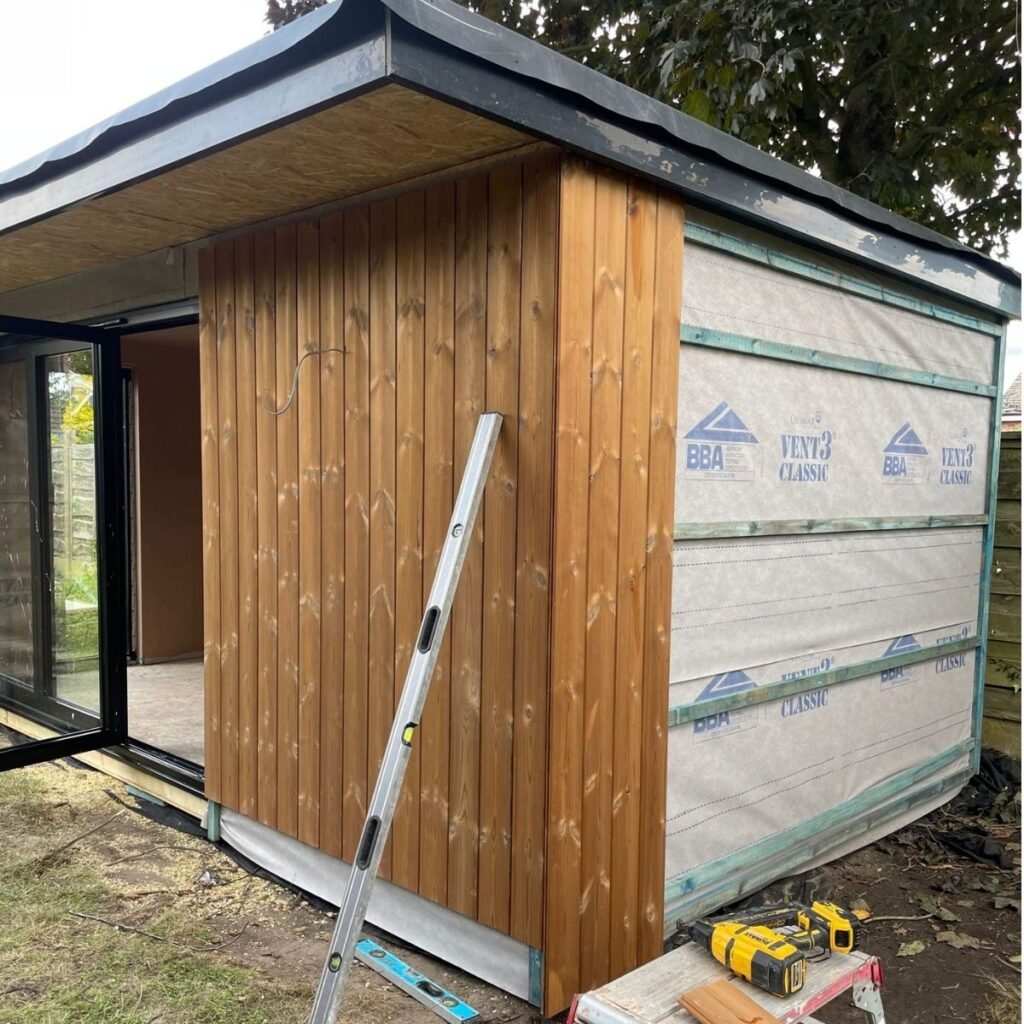 external thermowood cladding being installed for this garden office